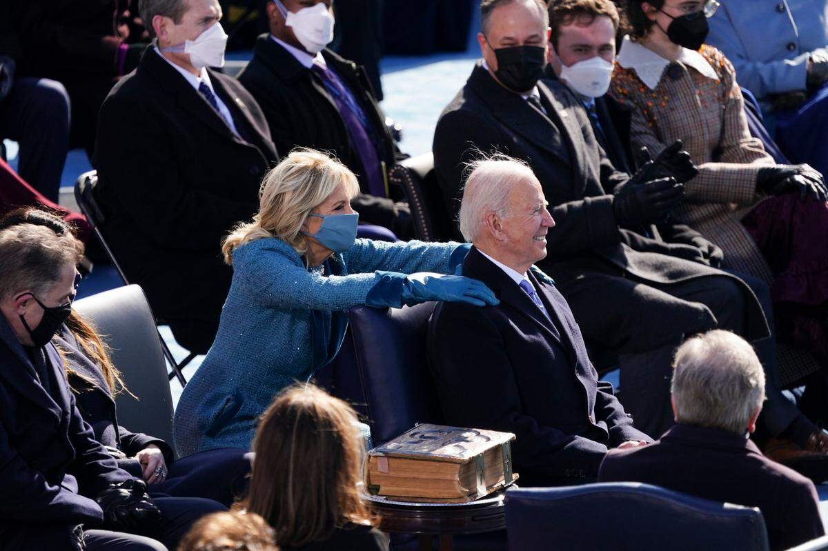 First lady Jill Biden places her hands on U.S. President Joe Biden after he is sworn in as 46th president of the United States during the 59th Presidential Inauguration at the U.S. Capitol in Washington, Wednesday, Jan. 20, 2021.