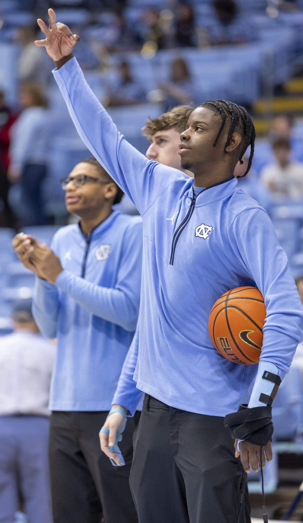 North Carolina forward Caleb Wilson (8) watches his teammates warm up for their game against Pitt on Saturday, February 14, 2026 at the Smith Center in Chapel Hill, N.C. Wilson is sidelined after fracturing his left hand in the game against Miami.