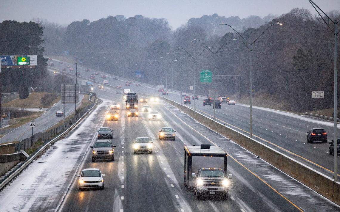 A view of afternoon rush hour traffic on Interstate 40 in Graham as snow flurries fall Friday, Dec. 10, 2025.