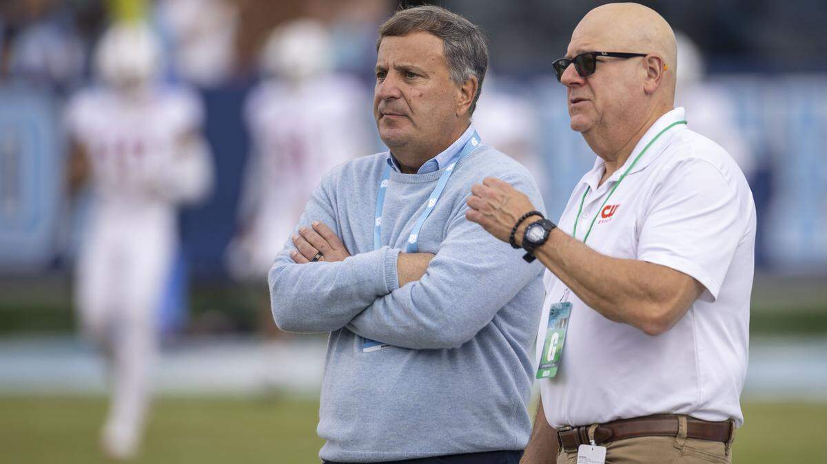 North Carolina football general manager Michael Lombardi, left, talks with staff from the CW network prior to the Tar Heels’ game against Stanford on Saturday, November 8, 2025 at Kenan Stadium in Chapel Hill, N.C.