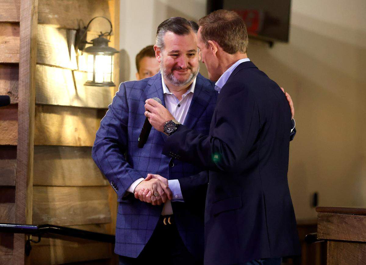 Texas Sen. Ted Cruz greets Republican U.S. Senate candidate Ted Budd after Budd introduced him during a campaign rally in Selma, N.C., Tuesday, Oct. 25, 2022.
