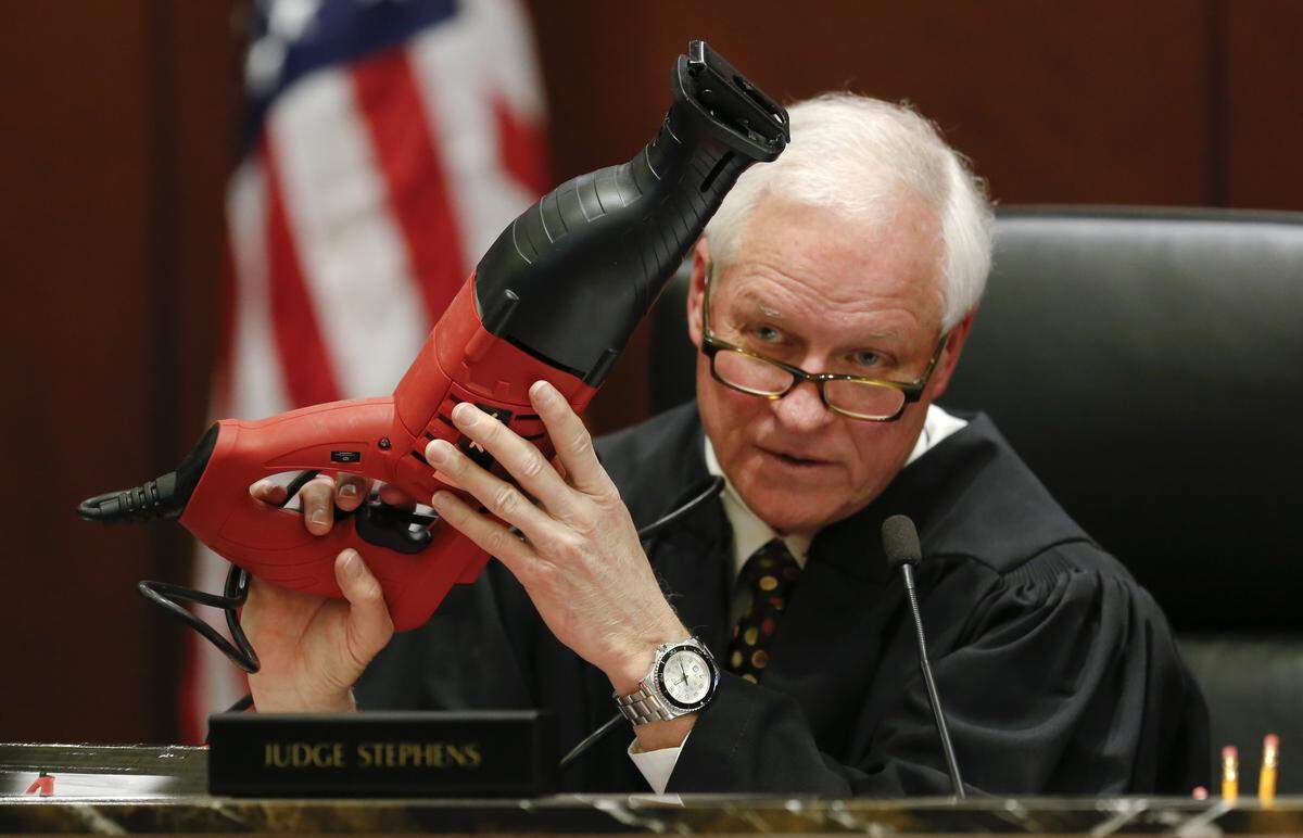 Judge Donald Stephens hold a reciprocating saw brought in to evidence that a jury requested to examine during deliberations in the Amanda Hayes, murder trial Tuesday, February 18, 2014, in the Wake County Justice Center. Hayes is accused of acting in concert with her husband Grant Hayes, 34, to murder Laura Jean Ackerson, 27, the mother of Grant Hayes’ two sons, in July 2011 and dismembering and disposing her body in a Texas creek.