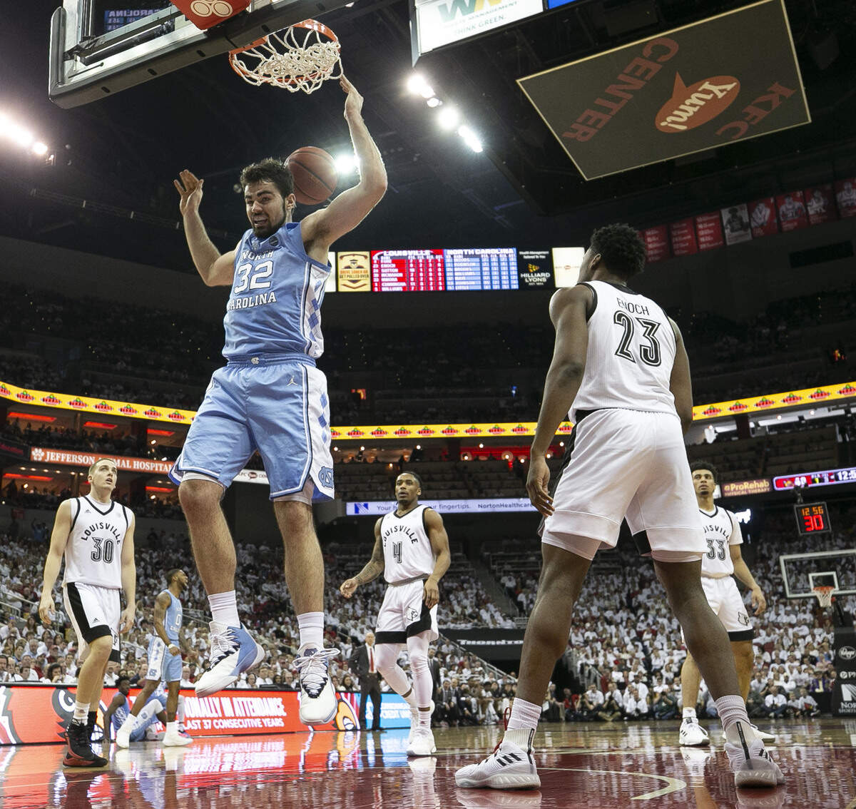 North Carolina’s Luke Maye (32) gets a dunk ahead of the Louisville defense of Ryan McMahon (30) and Steven Enoch (23) during the second half against Louisville on Saturday, February 2, 2019 at the KFC Yum! Center in Louisville, Ky.