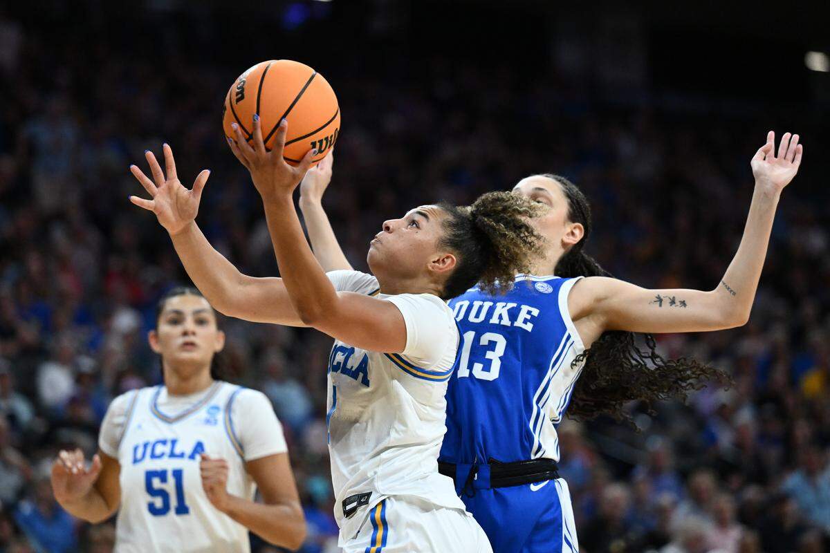UCLA’s Kiki Rice, center, takes a shot against Duke’s Jordan Wood during the second quarter in the teams’ Elite Eight game at the 2026 NCAA Women's Basketball Tournament at Golden 1 Center on March 29, 2026 in Sacramento, California.