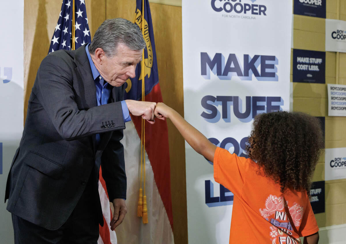 Former Gov. Roy Cooper greets Rae Gregory following a “Make Stuff Cost Less” campaign rally at the Graham Civic Center on Monday, July 13, 2026, in Graham, N.C.