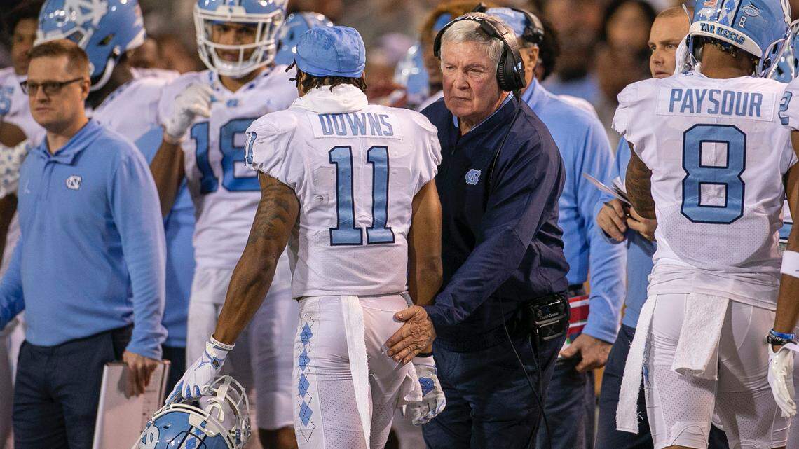 North Carolina coach Mack Brown gives wide receiver Josh Downs (11) a pat on the back after scoring on a 20-yard pass from quarterback Drake Maye to give the Tar Heels a 27-21 lead in the second quarter on Saturday, November 12, 2022 at Truist Field in Winston-Salem, N.C.