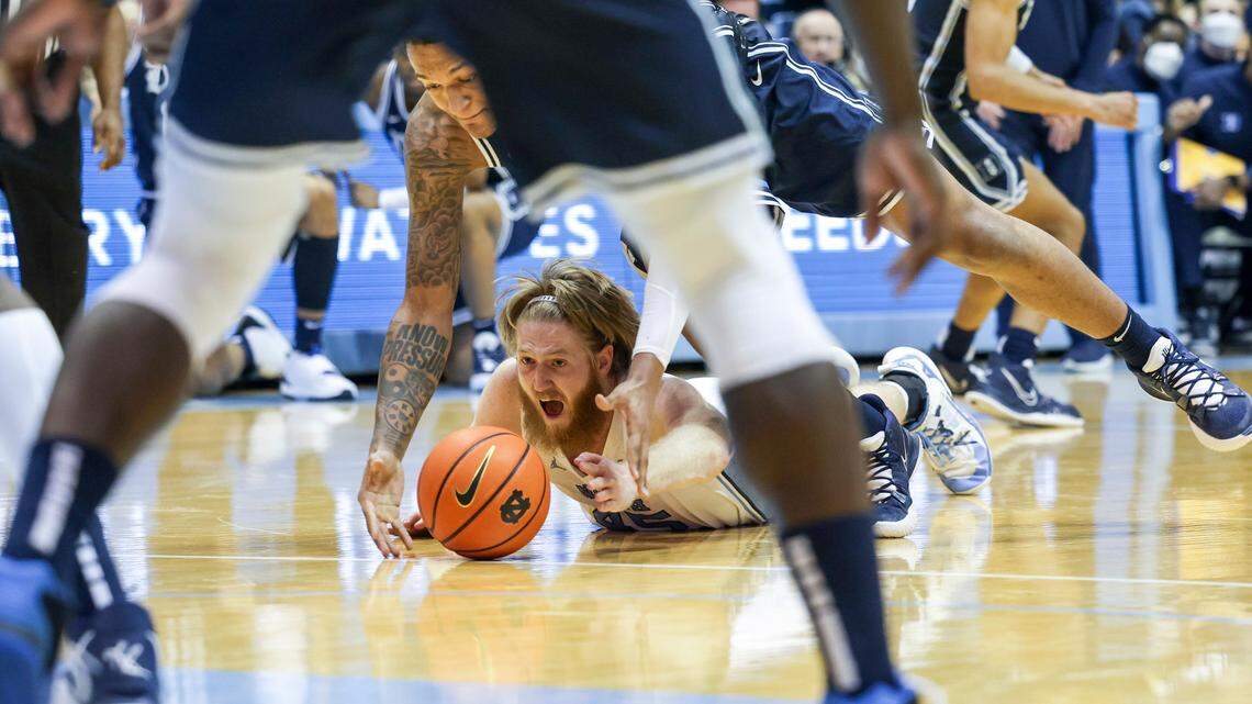 North Carolina’s Brady Manek (45) and Dukeís Paolo Banchero (5) scramble for the ball during the second half of UNCís game against Duke Saturday, Feb. 5, 2022 at the Dean Smith Center. Duke won 87-67.