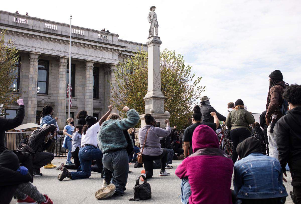 A large crowd, gathered for a rally and march to the polls, held an 8 minute and 46 second moment of silence for George Floyd, whose niece and nephew were present, in downtown Graham on Oct. 31, 2020.