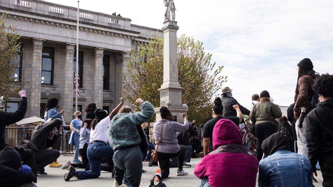 A large crowd, gathered for a rally and march to the polls, held an 8 minute and 46 second moment of silence for George Floyd, whose niece and nephew were present, in downtown Graham on Oct. 31, 2020.