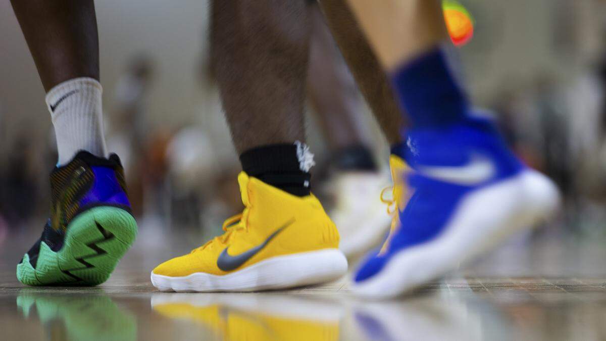 Colorful swoosh-adorned footwear on the court during Nike’s Elite Youth Basketball League (EYBL) tournament, at LakePoint Champions Center in Cartersville, Ga., May 12, 2018. A years-long federal investigation into college basketball recruiting prompted an NCAA commission to recommend substantial reforms to the youth basketball-industrial complex, where Nike and its top competitors, Adidas and Under Armour, exert significant influence. (Kevin D. Liles/The New York Times)