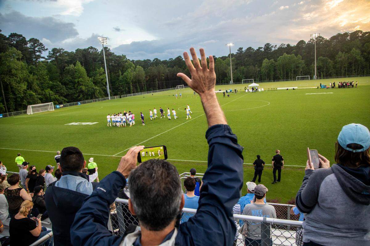 Fans celebrate a 2-1 UNC-Chapel Hill victory over Wake Forest during the Division I Men’s Soccer Championship quarterfinals at WakeMed Soccer Park in Cary Monday, May 10, 2021.