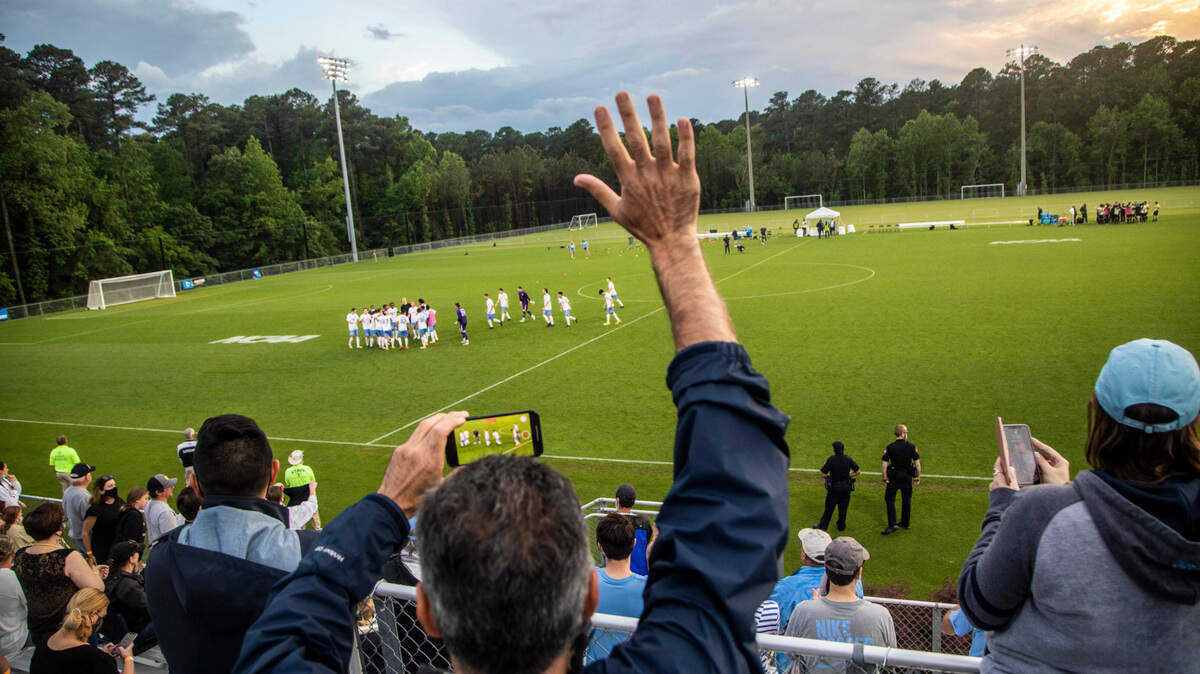Fans celebrate a 2-1 UNC-Chapel Hill victory over Wake Forest during the Division I Men’s Soccer Championship quarterfinals at WakeMed Soccer Park in Cary Monday, May 10, 2021.