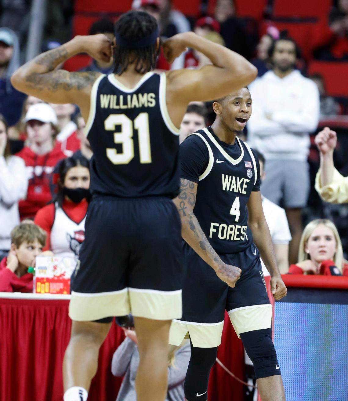 Wake Forest’s Daivien Williamson (4) and Alondes Williams (31) celebrate after Williamson made the basket while being fouled during the second half of Wake Forest’s 69-51 victory over N.C. State at PNC Arena in Raleigh, N.C., Wednesday, Feb. 9, 2022.