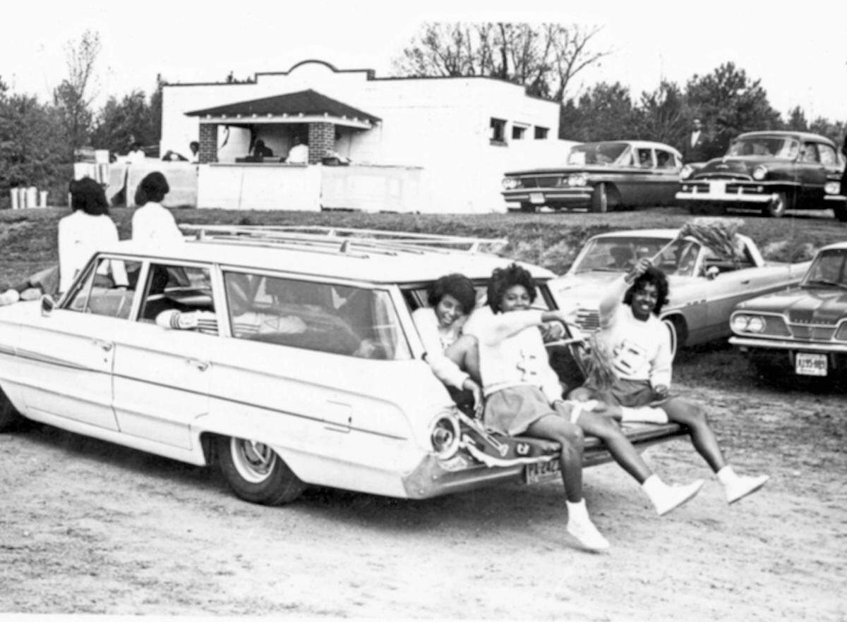 Tailgating cheerleaders ride through Raleigh’s Legion Park before a Shaw University Homecoming game.