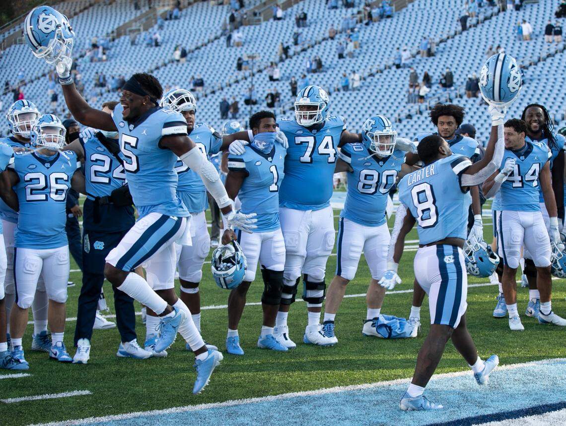 North Carolina’s North Carolina’s Dazz Newsome (5) and Michael Carter (8) celebrate the Tar Heels’ 59-53 victory over Wake Forest at Kenan Stadium on Saturday, November 14, 2020 in Chapel Hill, N.C.