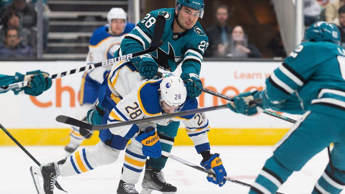 Feb 18, 2023; San Jose, California, USA; San Jose Sharks right wing Timo Meier (28) shoves Buffalo Sabres left wing Zemgus Girgensons (28) during the third period at SAP Center at San Jose. Mandatory Credit: Stan Szeto-USA TODAY Sports