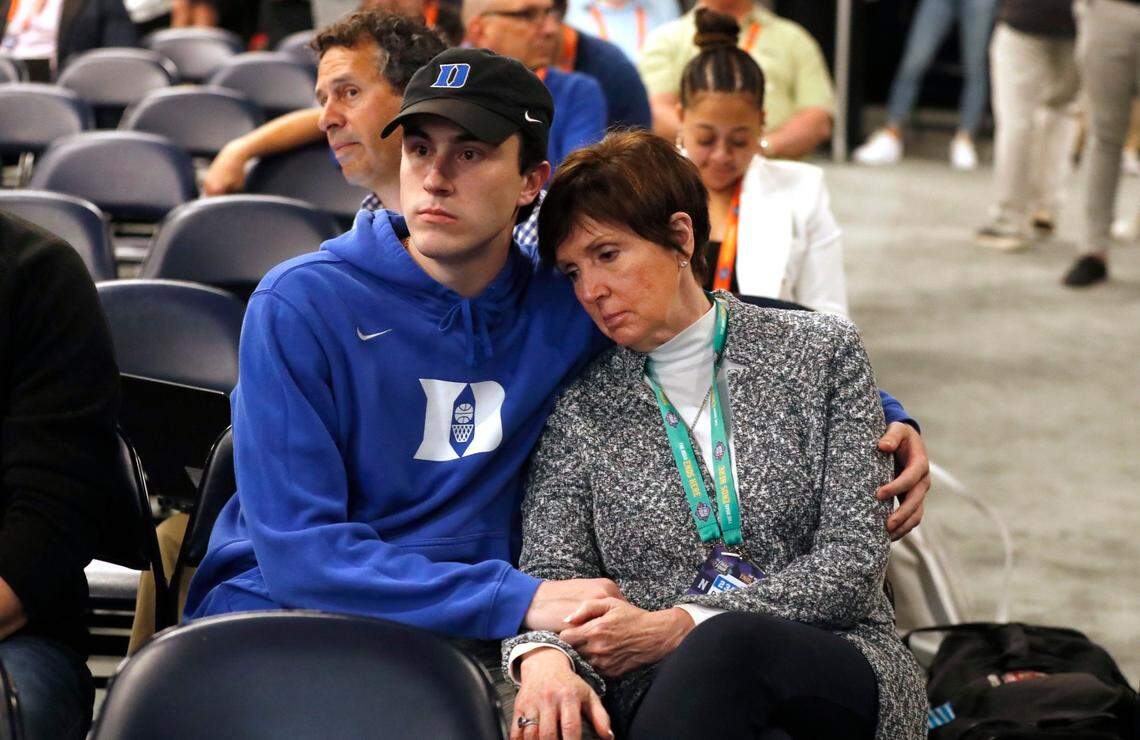 Joey Savarino and Mickie Krzyzewski listen to the Duke post game press conference after UNCs 81-77 victory over Duke in the Final Four at Caesars Superdome in New Orleans, La., Saturday, April 2, 2022.
