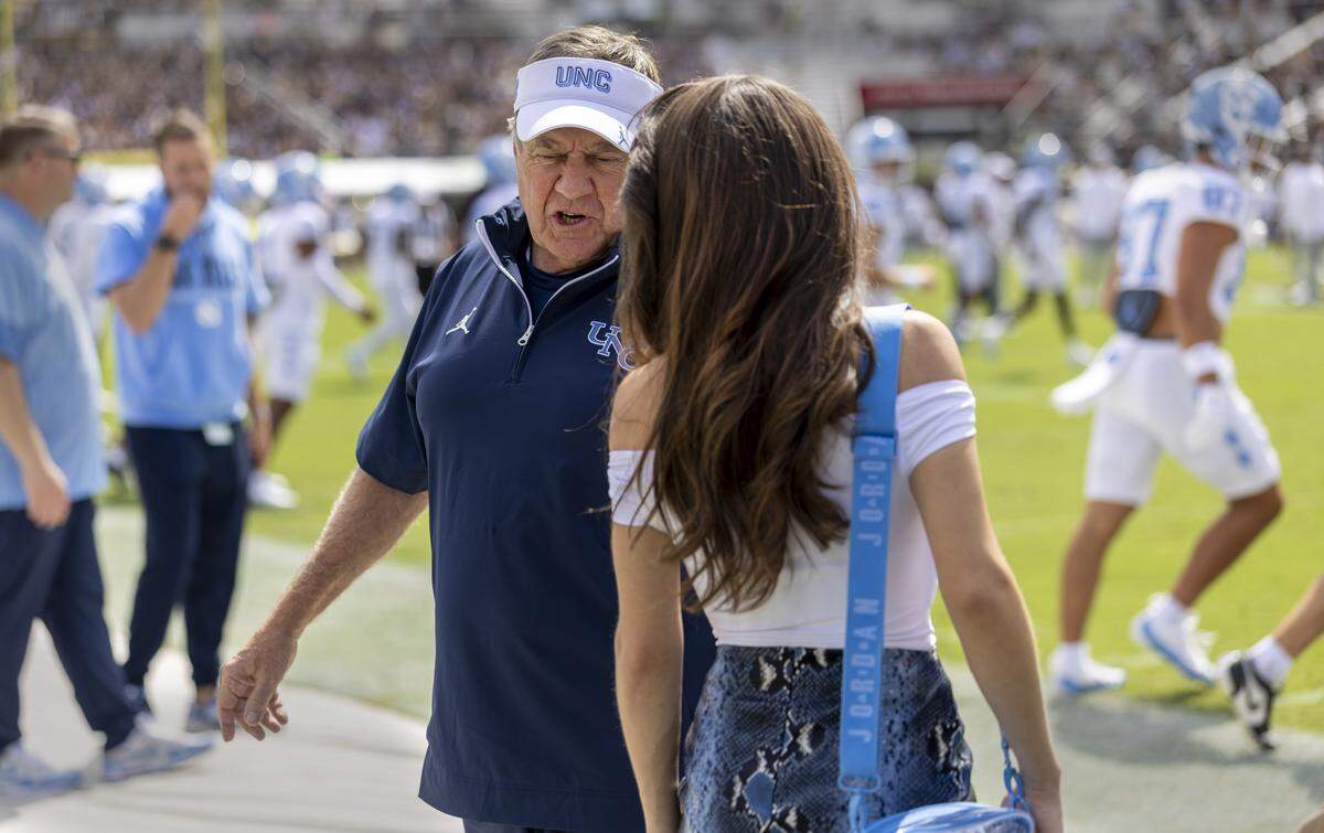 North Carolina coach Bill Belichick talks with Jordon Hudson prior to the Tar Heels’ game against UCF on Saturday, September 20, 2025 at Acrisure Bounce House Stadium in Orlando, Fla.
