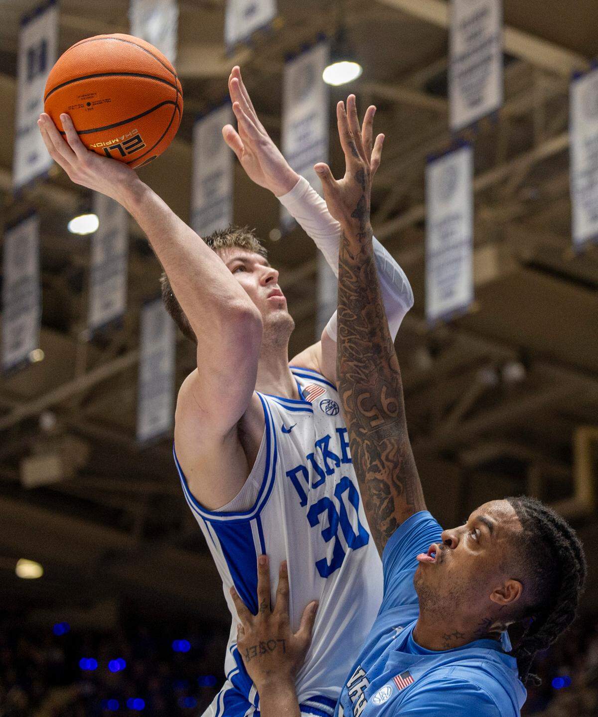 Duke’s Kyle Filipowski (30) puts up a shot against North Carolina’s Armando Bacot (5) in the first half on Saturday, March 9, 2024 at Cameron Indoor Stadium in Durham, N.C. Filipowski scored 23 points in the Blue Devils’ 84-79 loss