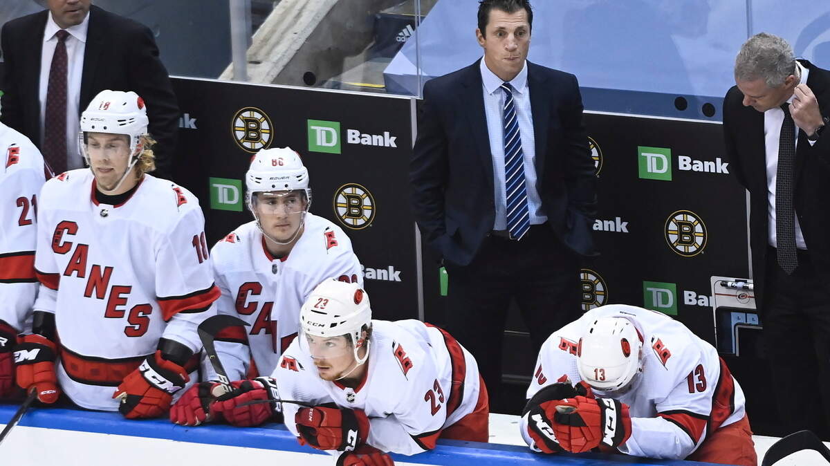 Carolina Hurricanes head coach Rod Brind’Amour, back center, looks on as players on the bench hang their heads after being eliminated by the Boston Bruins in an NHL Eastern Conference Stanley Cup playoff hockey game in Toronto, Ontario, on Wednesday, Aug. 19, 2020. (Nathan Denette/The Canadian Press via AP)
