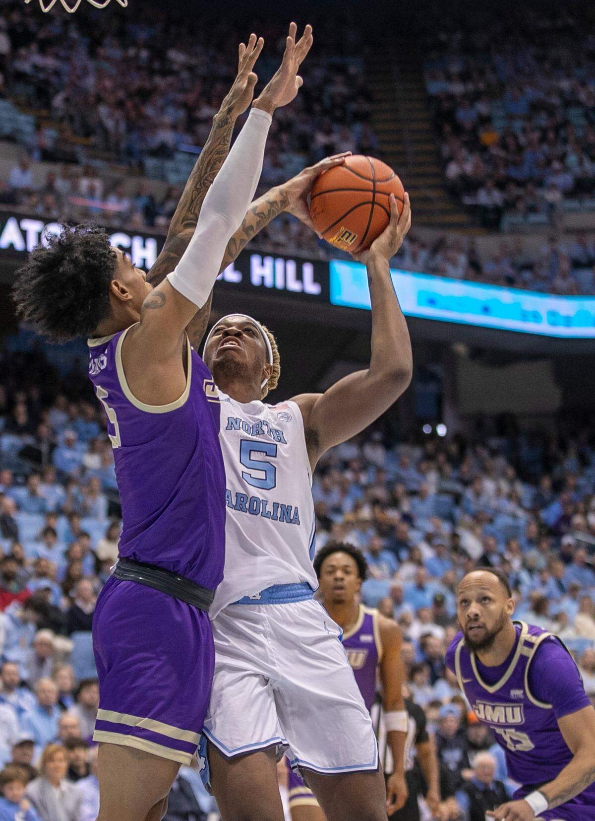North Carolina’s Armando Bacot (5) goes to the basket against James Madison’s Terrence Edwards (5) in the first half on Sunday, November 20, 2022 at the Smith Center in Chapel Hill, N.C. Bacot scored 19 points and had 23 rebounds in the Tar Heels’ 80-64 victory.