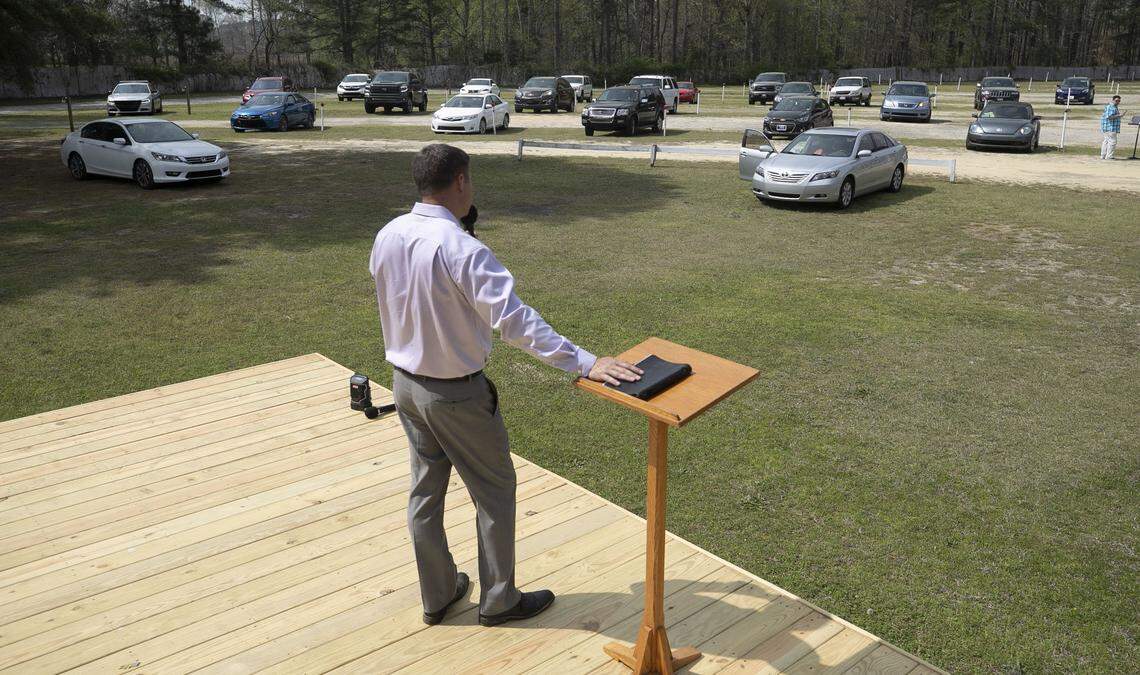 Pastor Will Breedlove of the Harriett Baptist Church in Henderson, N.C. delivers his sermon to his congregation in their cars on Sunday, March 29, 2020 at the Raleigh Road Outdoor Theatre in Henderson, N.C.