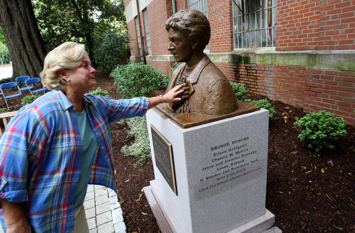 Donna Brewer, a longtime friend of Kay Yow, touches the likeness of the former N.C. State women’s basketball coach at the 2010 dedication of ‘Coaches’ Corner - Kay Yow Memorial.’ Students raised funds for the memorial to Yow, who died last year after a long battle with cancer.