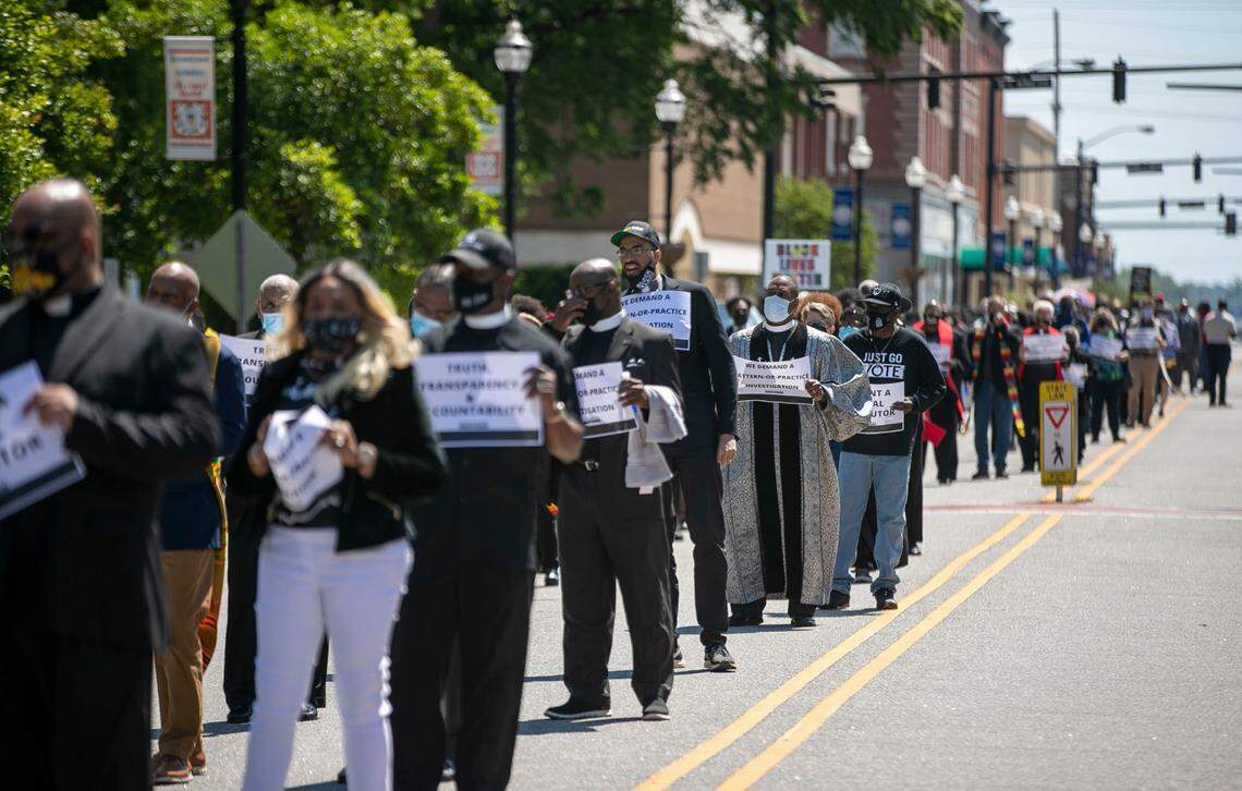 Religious leaders line Main Street in Elizabeth City, N.C. on Saturday morning May 8. 2021, during a march demanding transparency and accountability in the death of Andrew Brown Jr., who was fatally shot outside his home last month by Pasquotank County deputies serving search and arrest warrants.