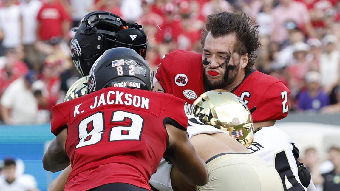Wake Forest linebacker Dylan Hazen (24) hits N.C. State quarterback Grayson McCall (2) during the first half of N.C. State’s game against Wake Forest at Carter-Finley Stadium in Raleigh, N.C., Saturday, Oct. 5, 2024. The hit knocked McCall out of the game.