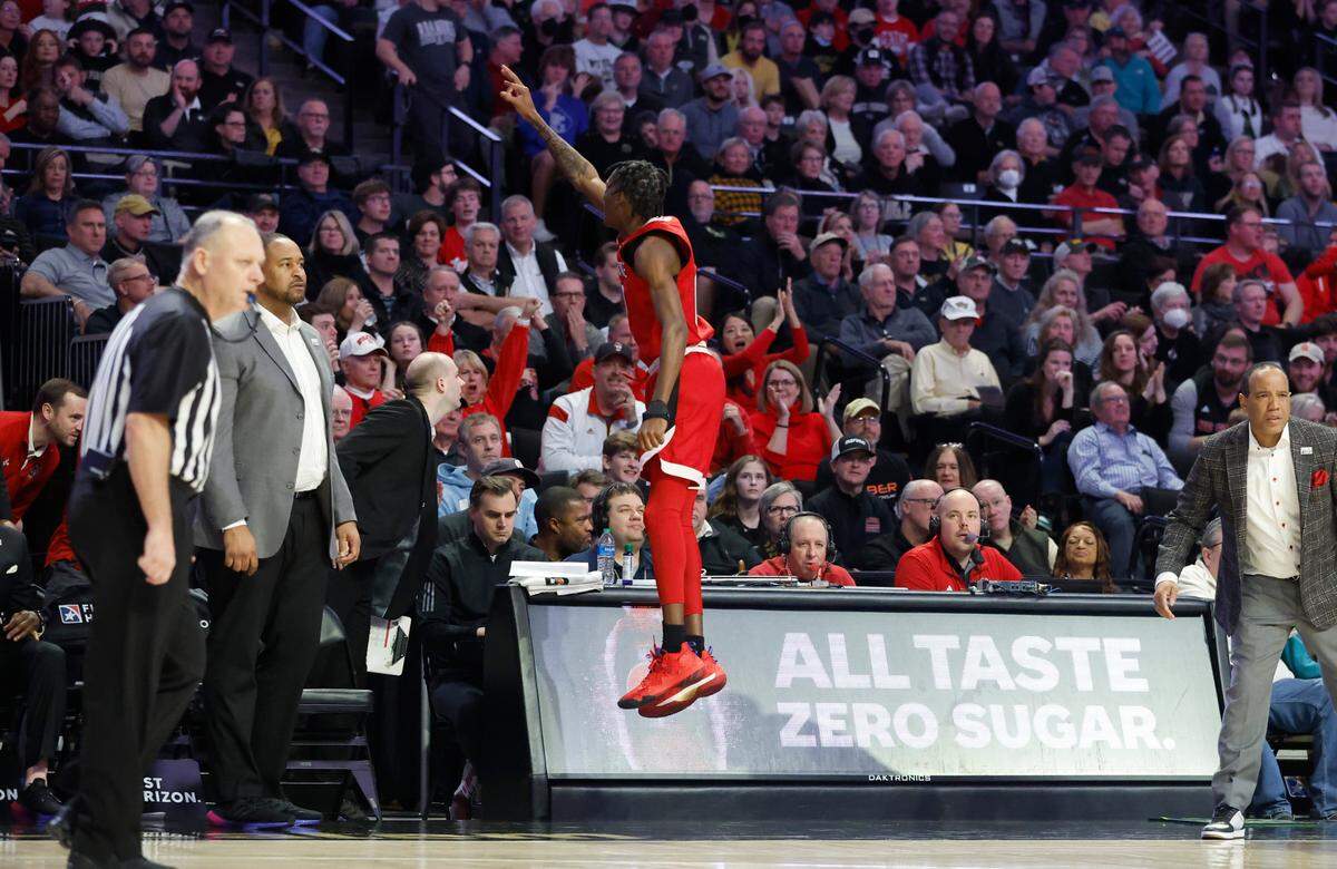 N.C. State’s Terquavion Smith (0) jumps from the bench after LJ Thomas hit a three-pointer during the second half of N.C. State’s 79-77 victory over Wake Forest at Joel Coliseum in Winston-Salem, N.C., Saturday, Jan. 28, 2023.