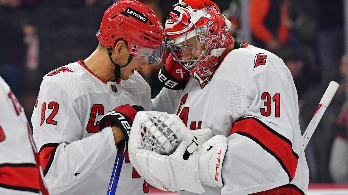 Oct 30, 2023; Philadelphia, Pennsylvania, USA; Carolina Hurricanes center Jesperi Kotkaniemi (82) and goaltender Frederik Andersen (31) celebrate win against the Philadelphia Flyers at Wells Fargo Center. Mandatory Credit: Eric Hartline-USA TODAY Sports