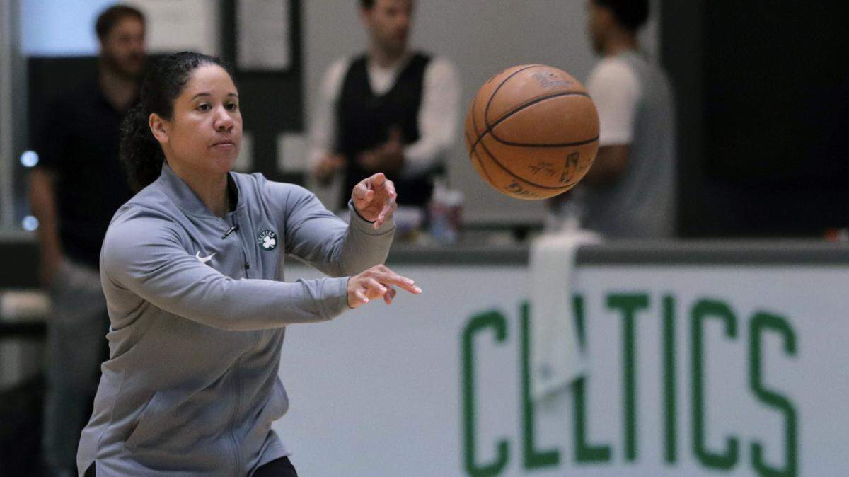 FILE - In this July 1, 2019, file photo, Boston Celtics assistant coach Kara Lawson passes the ball at the team’s training facility in Boston. Celtics guard Gordon Hayward said Lawson has already made her presence felt. ÒSheÕs been good as far as just the experience she has as a basketball player,Ó Hayward said. ÒReading the game and kind of little things she sees coaching on the sideline. Having somebody that well-versed in basketball, that experience is good.Ó