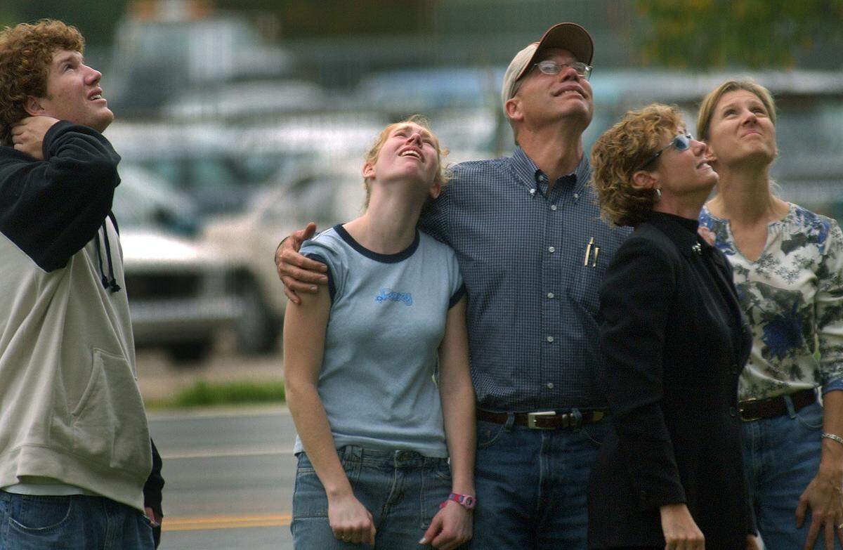 Steve Cox, left, and his mother Diane Cox, right, join the family of Nolan Myers -  sister Jourdan, 14, left, and his parents Philip and Terrie - at the site of an accident Saturday night that killed Nolan and five others who had stopped to help victims of another car accident. The group was watching balloons float away that were released in Nolan's memory. Nolan, a student at Campbell University, grew up in Minnesota where his family still lives. There were 18 balloons, one for each year of Nolan's life, that were were sent off with messages of thanks from his family. Cox is a fellow student at Campbell and close friend of Nolan's.