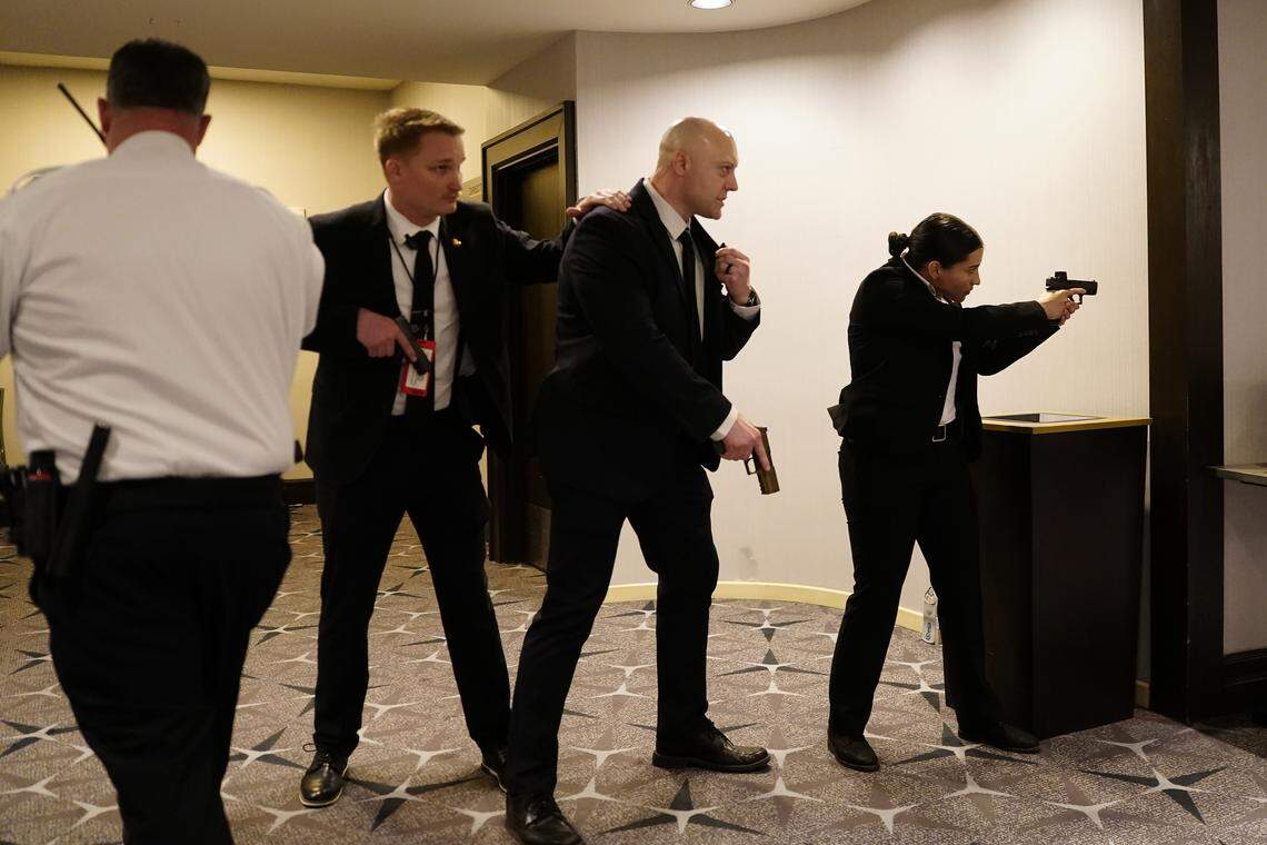 Federal agents draw their guns out after an incident at the annual White House Correspondents Association Dinner April 25, 2026 in Washington, DC. According to reports, President Donald Trump, along with other government officials, were evacuated from the Washington Hilton after what sounded like gun fire. 