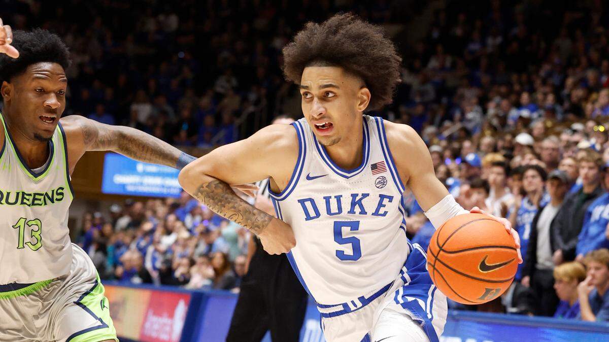 Duke’s Tyrese Proctor (5) drives to the basket past Queens’ Deyton Albury (13) during the first half of Duke’s game against Queens University at Cameron Indoor Stadium in Durham, N.C., Saturday, Dec. 30, 2023.