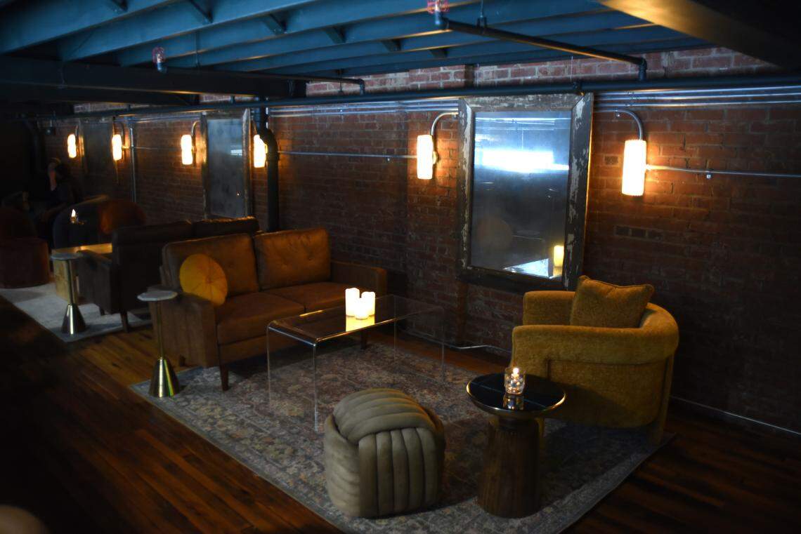 After grabbing drinks at the bar, patrons can head upstairs to a mezzanine lounge at the new Delancey Tavern in Durham.