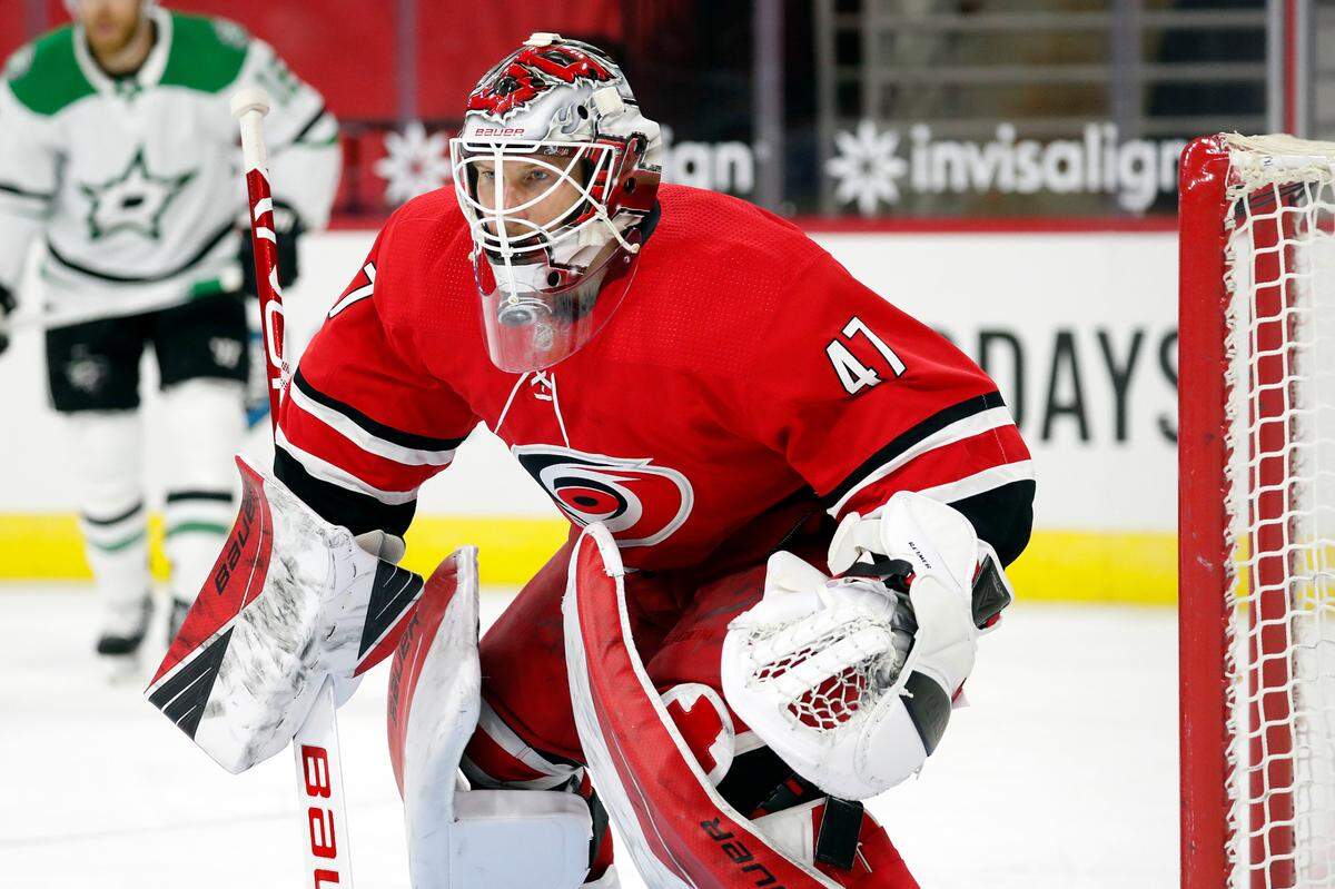 Carolina Hurricanes goaltender James Reimer (47) yes the puck against the Dallas Stars during the third period of an NHL hockey game in Raleigh, N.C., Sunday, Jan. 31, 2021. (AP Photo/Karl B DeBlaker)
