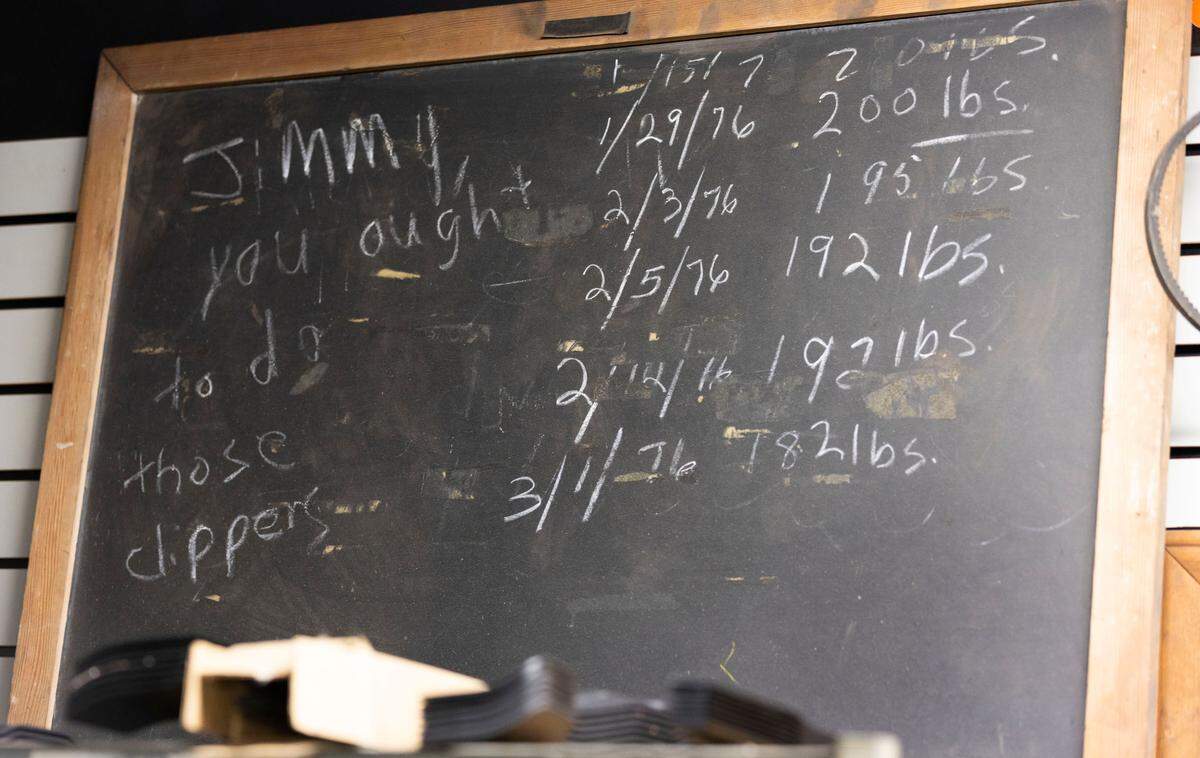 An old chalkboard sits on top of a cabinet at Wilson’s Outdoor Equipment Tuesday, April 26, 2022. After more than five decades in business, Wilson’s Outdoor Equipment is closing up shop this spring, as the downtown Raleigh property it’s called home since 1968 gets demolished to make way for a high-rise apartment building.