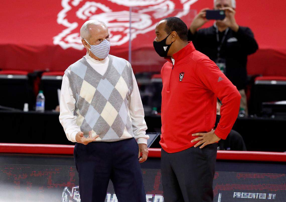 North Carolina head coach Roy Williams and N.C. State head coach Kevin Keatts talk before N.C. State’s game against UNC at PNC Arena in Raleigh, N.C., Tuesday, December 22, 2020.