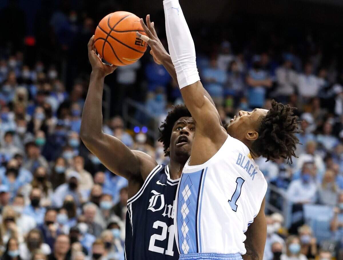 Dukes A.J. Griffin (21) shoots as North Carolina’s Leaky Black (1) defends during the first half of UNCs game against Duke at the Smith Center in Chapel Hill, N.C., Saturday, Feb. 5, 2022.