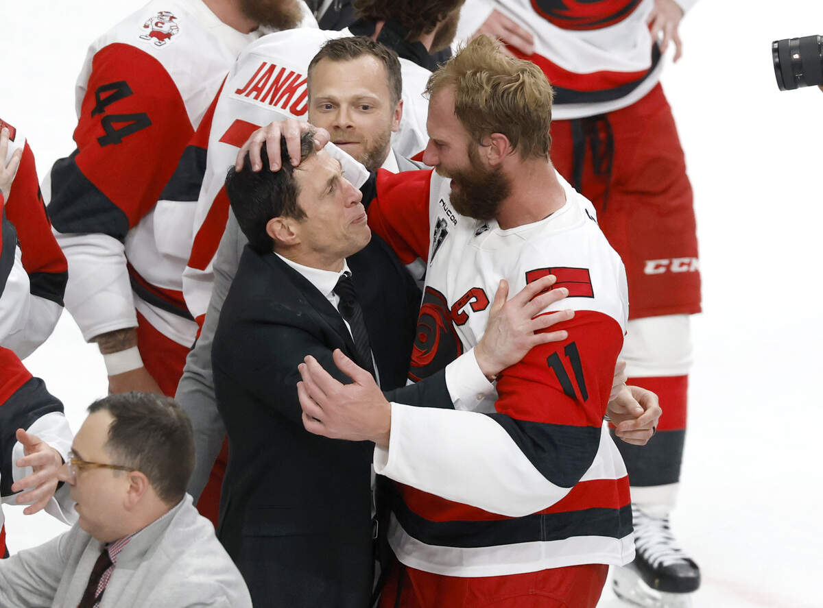 Canes coach Rod Brind'Amour and Jordan Staal (11) hug after the Hurricanes’ 3-0 victory over the Vegas Golden Knights to win the Stanley Cup at T-Mobile Arena in Las Vegas, Nev., Sunday, June 14, 2026.