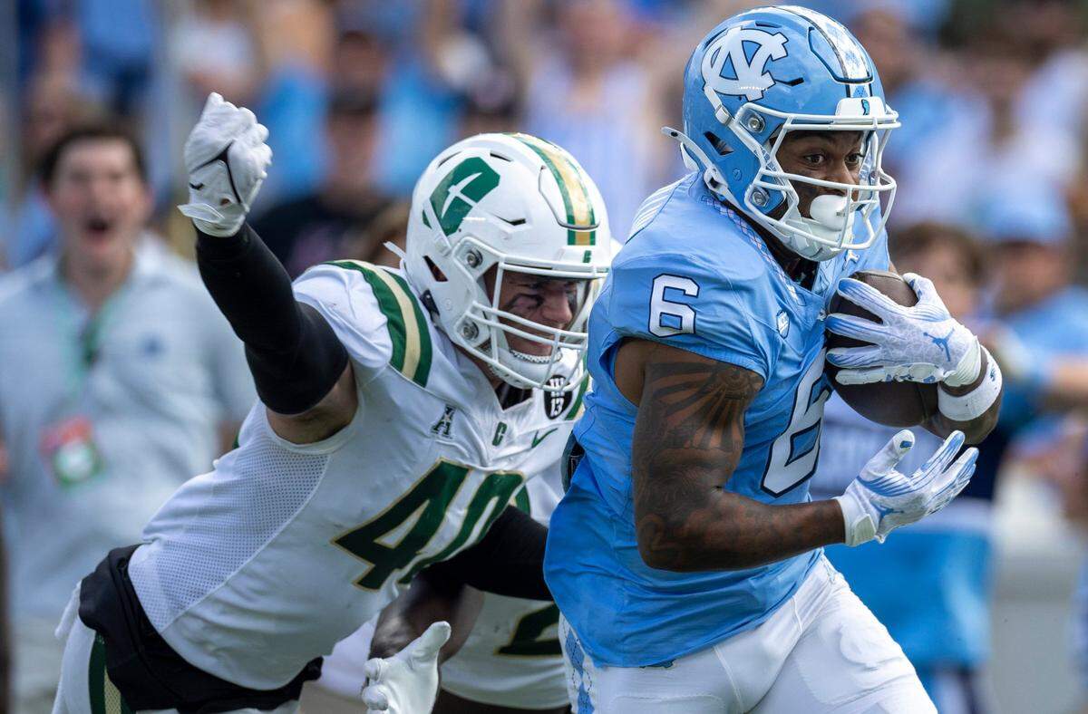 North Carolina wide receiver Nate McCollum (6) scores on a 37-yard carry ahead of Charlotte linebacker Reid Williford (4) to give the Tar Heels a 14-3 lead over Charlotte in the first quarter on Saturday, September 7, 2024 at Kenan Stadium in Chapel Hill, N.C.