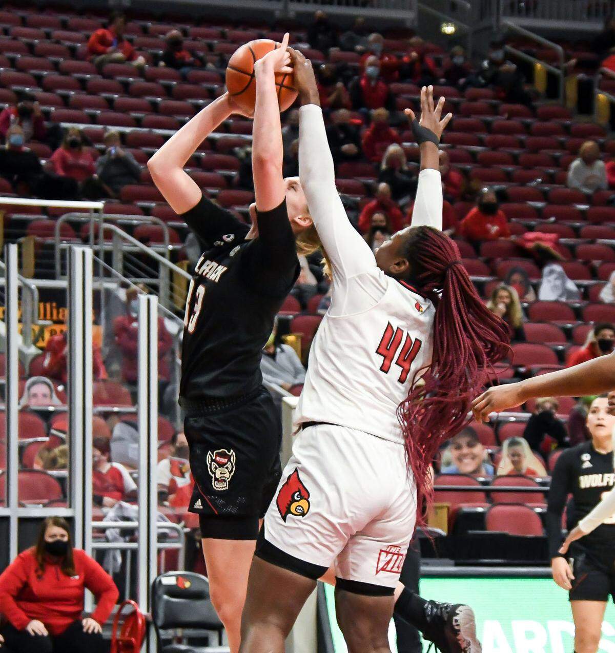 N.C. State’s Elissa Cunane (33) shoots while Louisville’s Olivia Cochran (44) defends during the Wolfpack’s game against Louisville at KFC Yum! Center in Louisville, Ky. Monday, February 1, 2021.