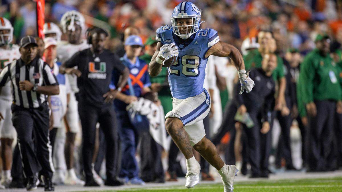 North Carolina running back Omarion Hampton (28) picks up 16-yards on a pass completion from quarterback Drake Maye in the fourth quarter against Miami on Saturday, October 14, 2023 at Kenan Stadium in Chapel Hill, N.C. Hampton rushed for 197 yards and one touchdown in the Tar Heels’ 41-31 victory.