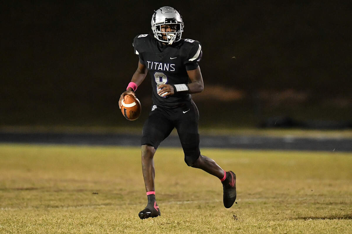 South Garner quarterback Chase Hardy (8) runs and looks for an opening against Garner during the first half. The South Garner Titans and the Garner Trojans met in a conference football game in Raleigh, N.C. October 17, 2025