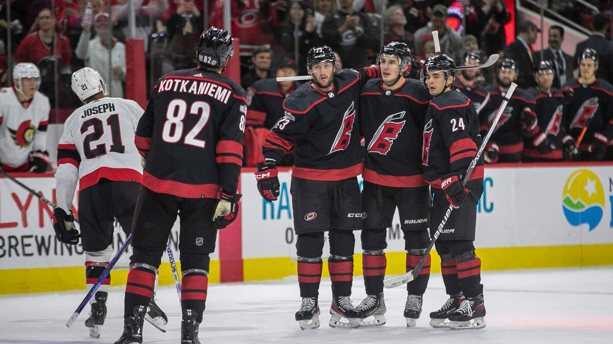 Carolina Hurricanes’ Jesperi Kotkaniemi (82), Stefan Noesen (23), Brady Skjei (76) and Seth Jarvis (24) celebrate a goal by Skjei to take a 2-0 lead over Ottawa during the first period on Tuesday, April 4, 2023 at PNC Arena in Raleigh, N.C.