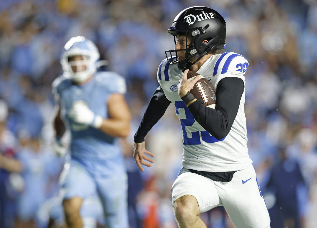 Duke’s Todd Pelino runs the ball after faking a field goal attempt during the second half of the Blue Devils’ 32-25 victory over North Carolina on Saturday, Nov. 22, 2025, at Kenan Stadium in Chapel Hill, N.C.