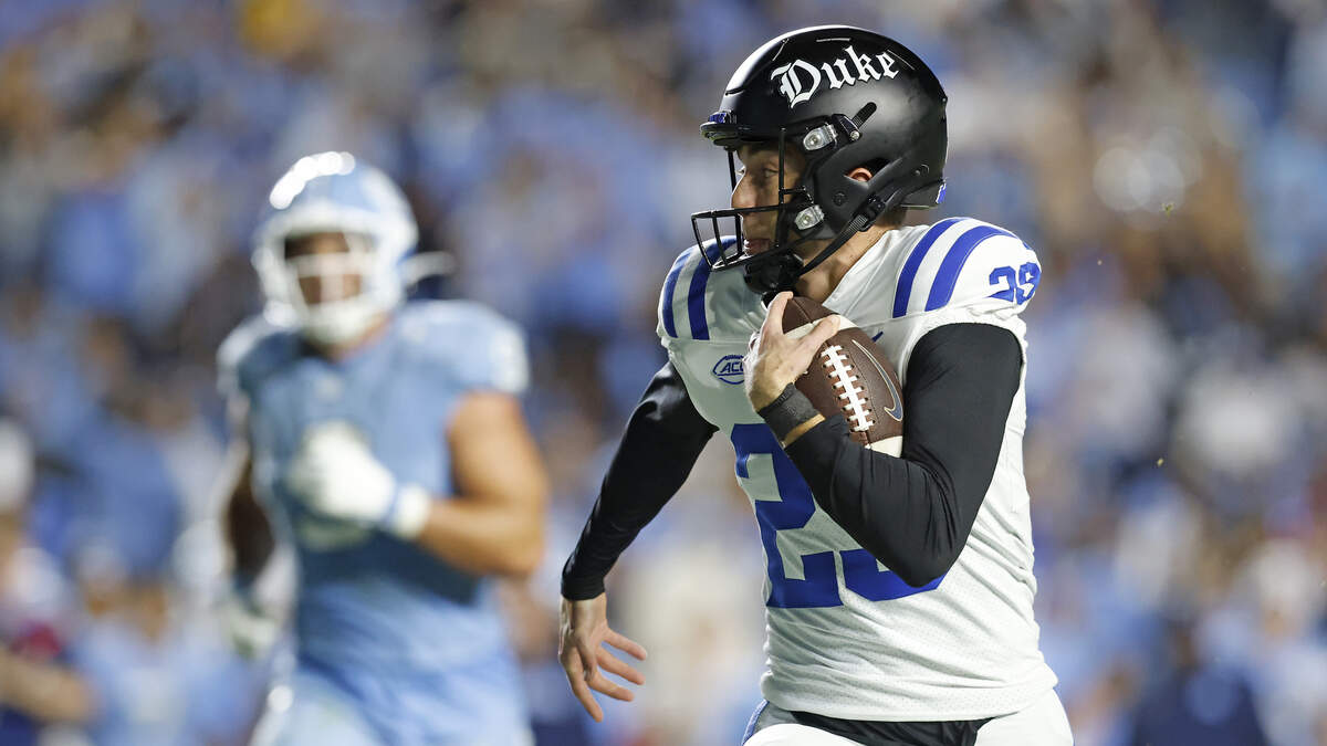 Duke’s Todd Pelino runs the ball after faking a field goal attempt during the second half of the Blue Devils’ 32-25 victory over North Carolina on Saturday, Nov. 22, 2025, at Kenan Stadium in Chapel Hill, N.C.