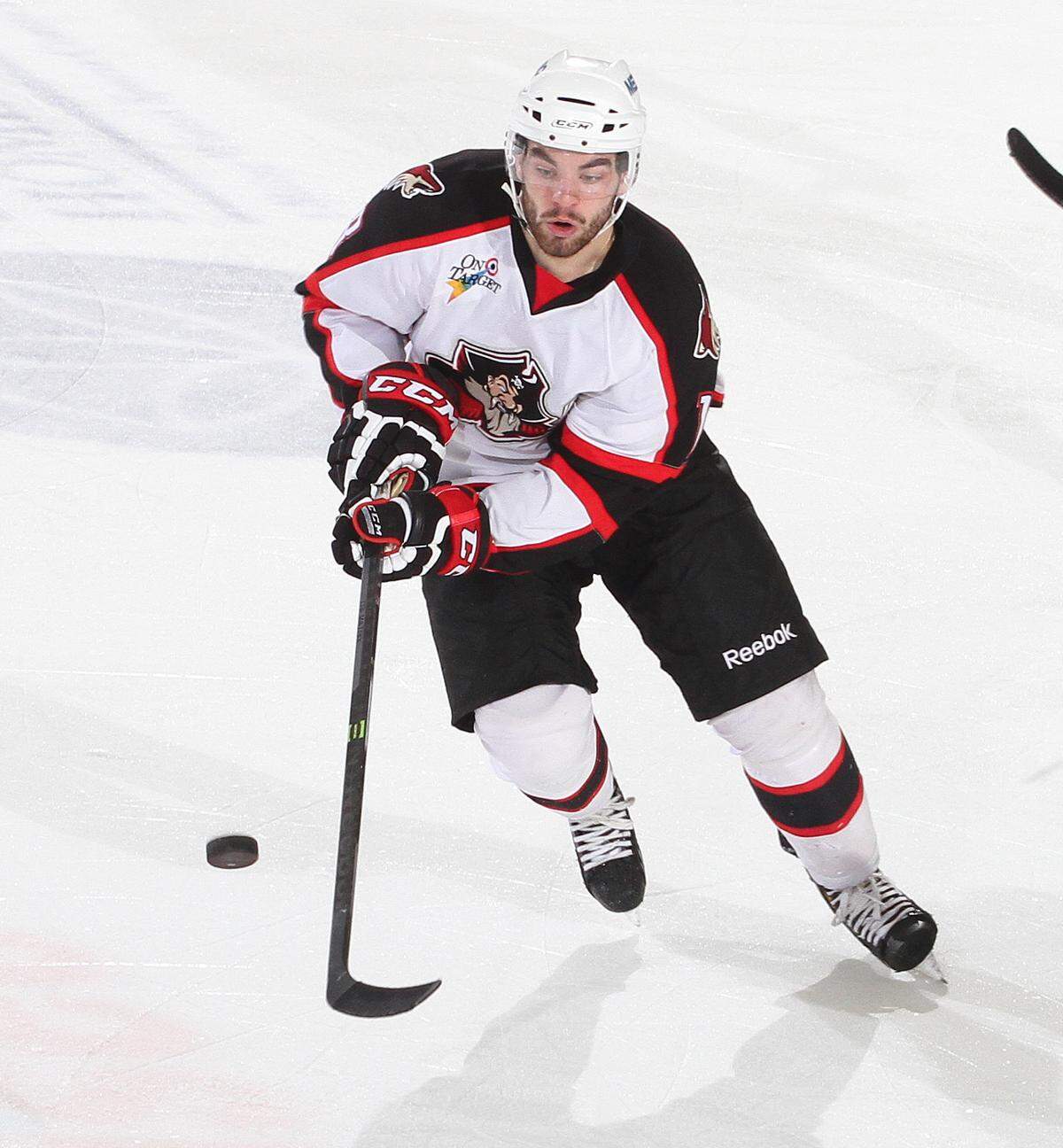 Jordan Martinook, then of the Portland Pirates in the American Hockey League, rushes the puck during a game.