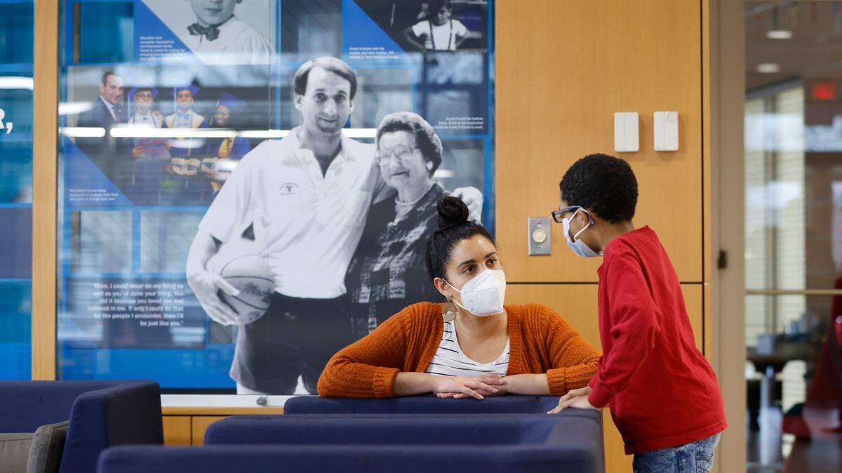 Cecily Jobe, lead tutor, talks with Kaleb Blue at the Emily K Center in Durham, N.C., Thursday, Feb. 24, 2022.